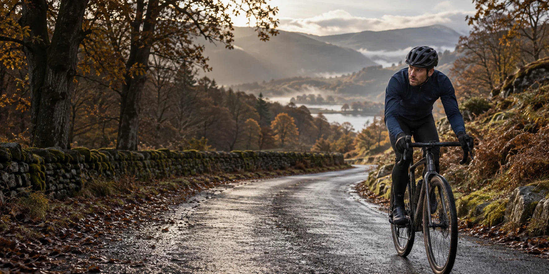 Cyclist in a long-sleeved jacket riding a quiet autumn lane beneath golden trees